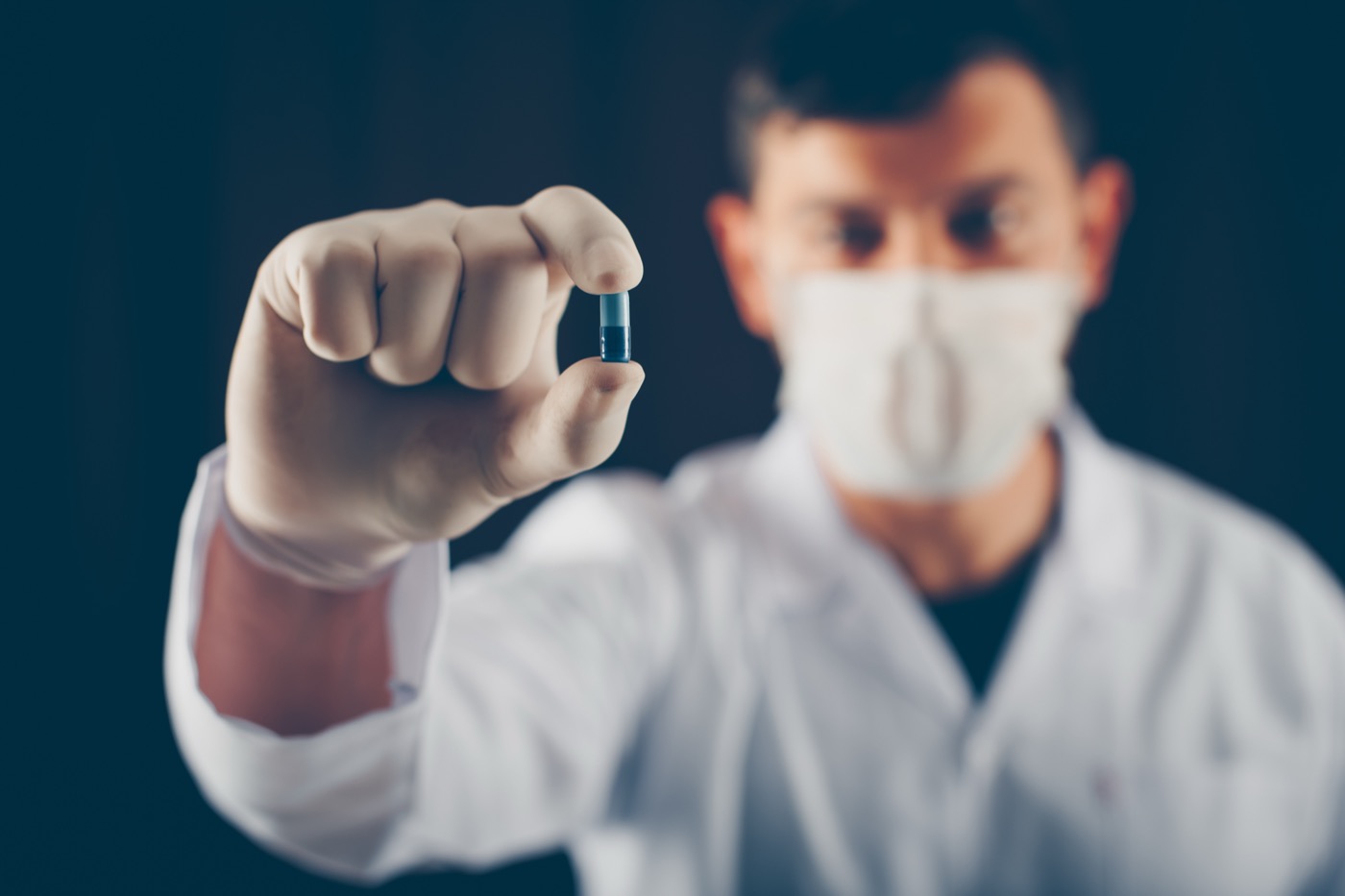 Doctor holding a supplement capsule