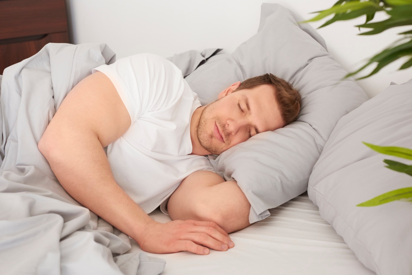 Man sleeping comfortably in bed